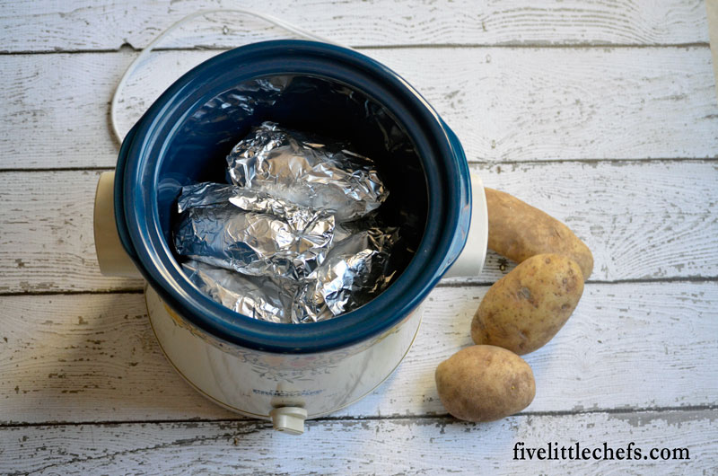 How to cook baked potatoes in a crock pot. A great way to make baked potatoes while freeing up space in your oven.