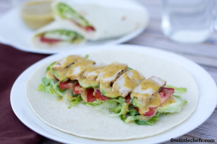 Honey Mustard Chicken Wrap is a fast and easy recipe when you are using leftover Honey Mustard Grilled Chicken. This is great for lunch, dinner or on the go! It is packed with a variety of vegetables to give texture to each bite. fivelittlechefs.com